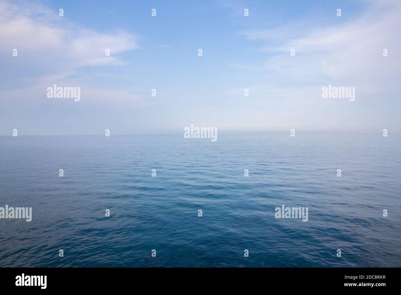 Background of clear blue sky and quiet sea Stock Photo