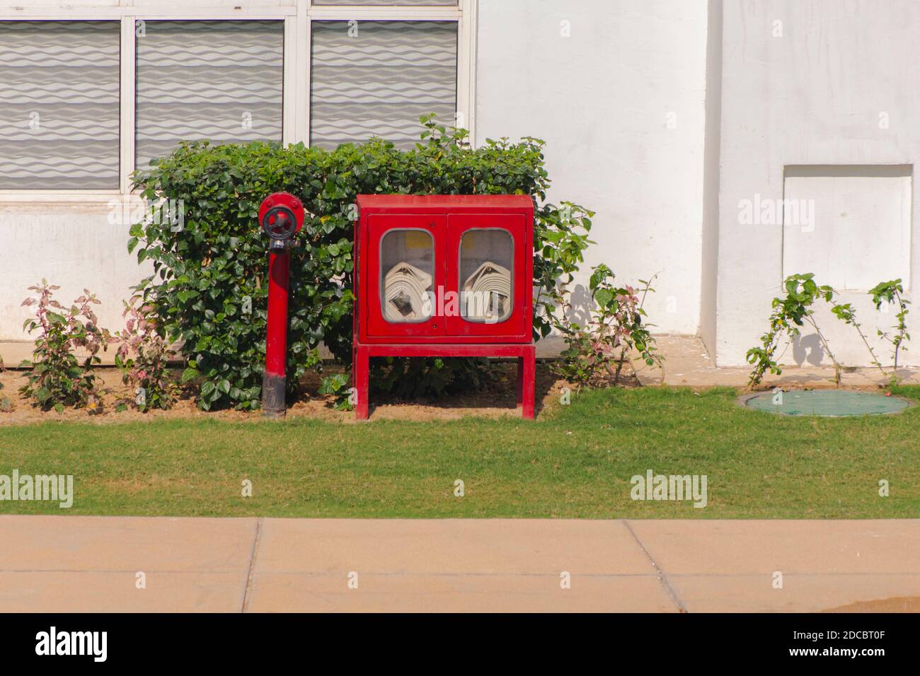 A double fire hose cabinet or box standing on ground Stock Photo