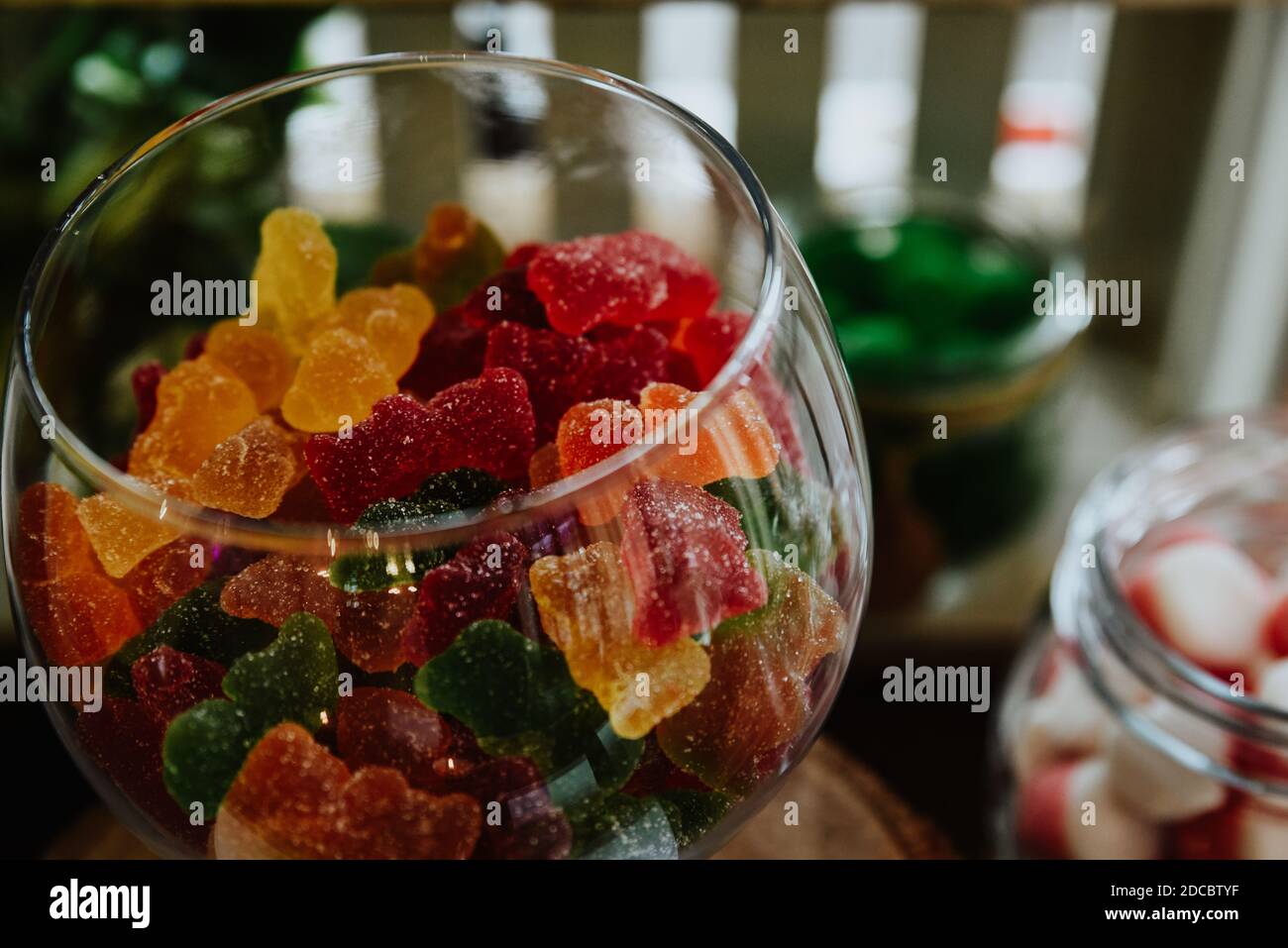 A high angle shot of sugarcovered gummy bears in a crystal bowl