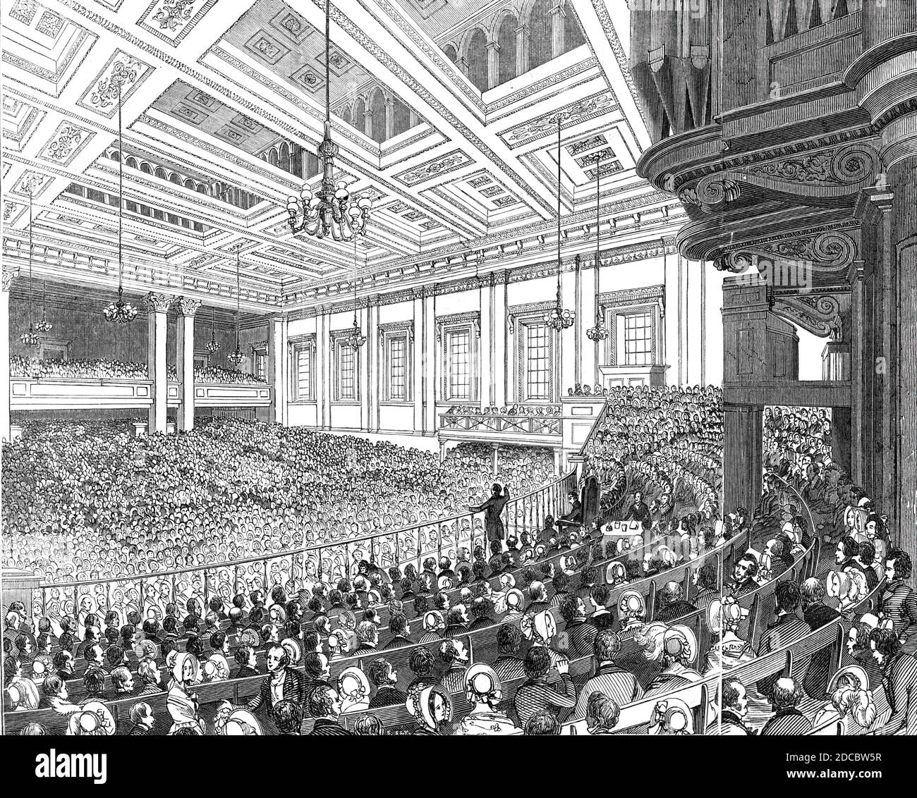 &quot;May Meetings&quot; in the Metropolis - interior of Exeter Hall, 1844. Exeter Hall in the Strand, London: '...herein are held several anniversaries during the month of May. Our engraving represents one of these impressive reunions...The Great Hall is 90 feet broad, 138 in length, and 48 high, and is lighted by 18 large windows. It will hold 3000 persons with comfort, and 4000 crowded. The platform, at the east end, shown in our engraving, will accommodate 500 persons, and is fenced from the rest of the hall by a railing, within which is seated the chairman, surrounded by persons influenti Stock Photo