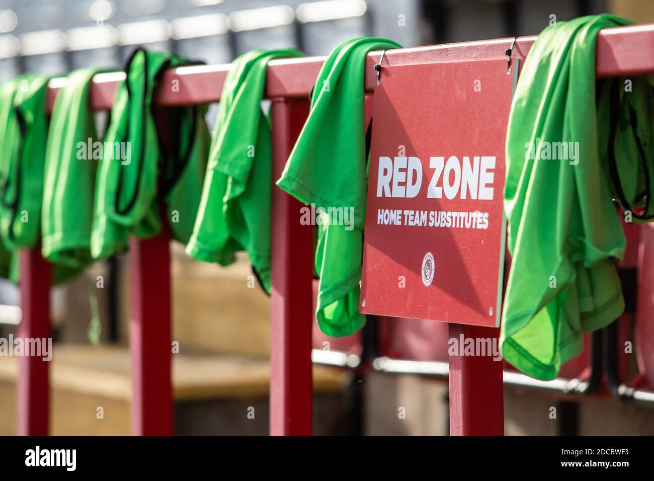 Bibs used by substitutes in football match hang over railing. Ready for