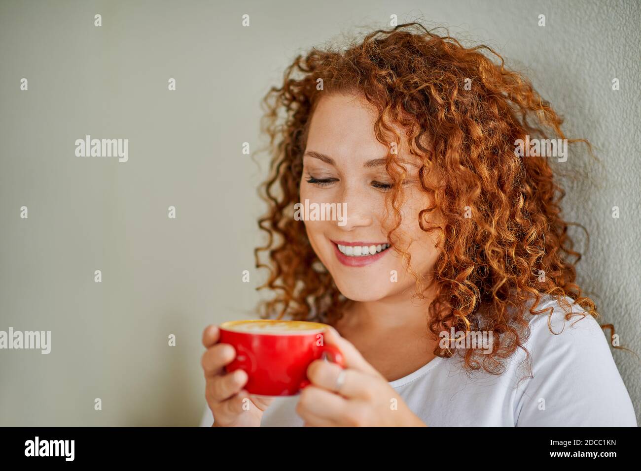 A young woman drinks coffee Stock Photo