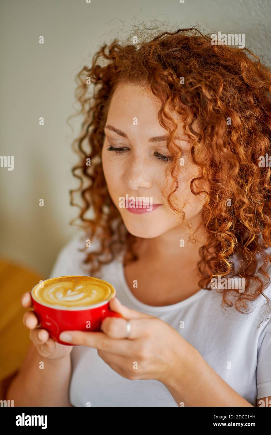 A young woman drinks coffee Stock Photo