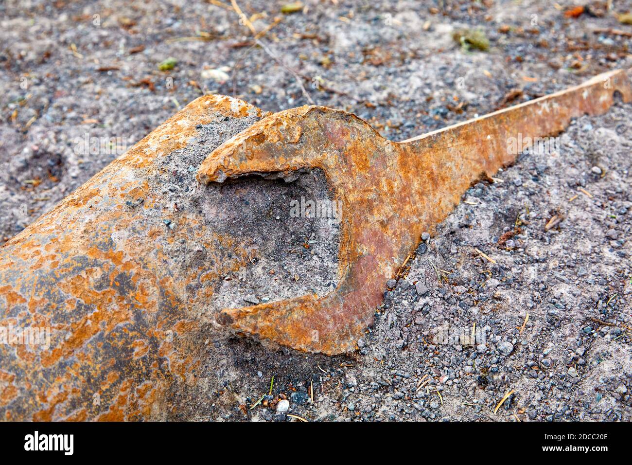 Industrial large metal spanner lying on the ground Stock Photo