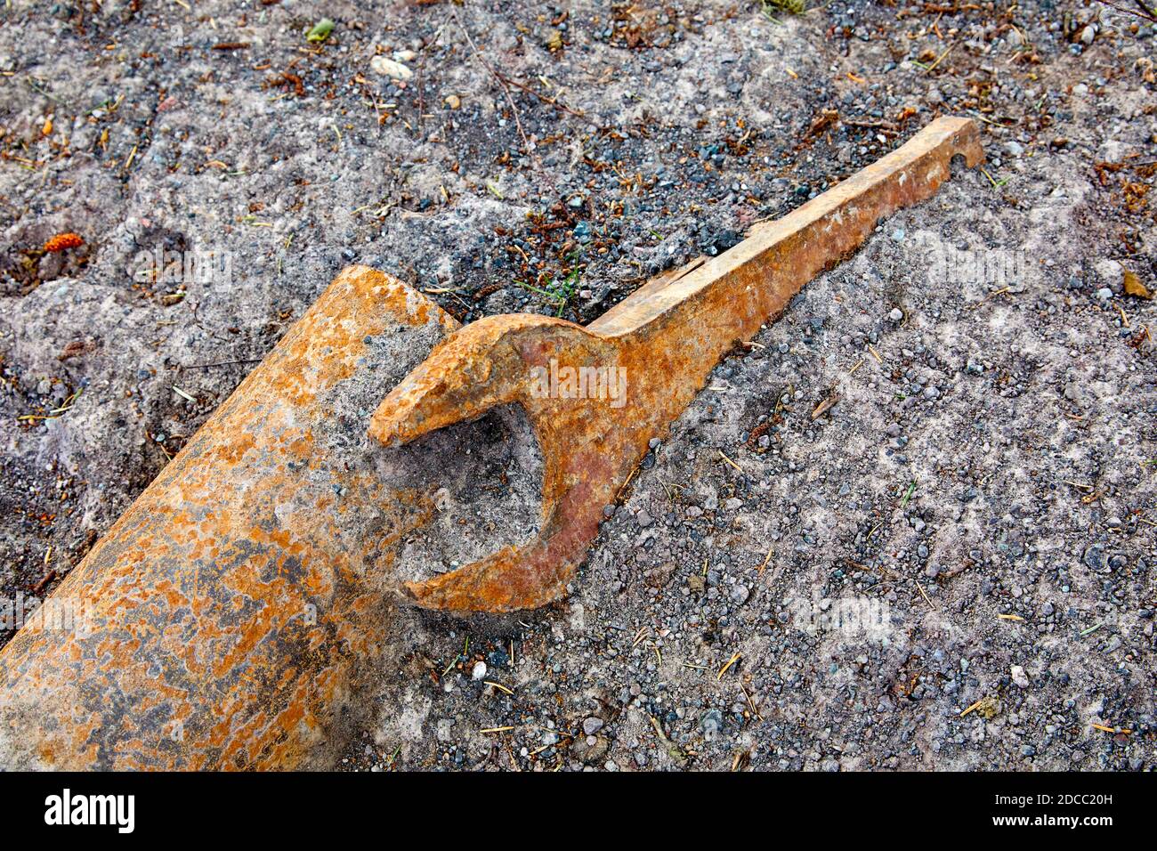 Industrial large metal spanner lying on the ground Stock Photo