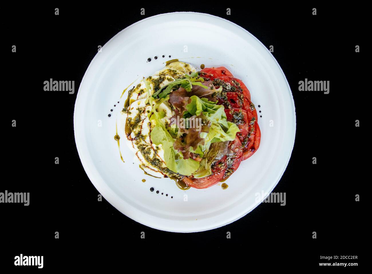Vegetable salad with tomato cheese, on a white plate, isolate. Stock Photo