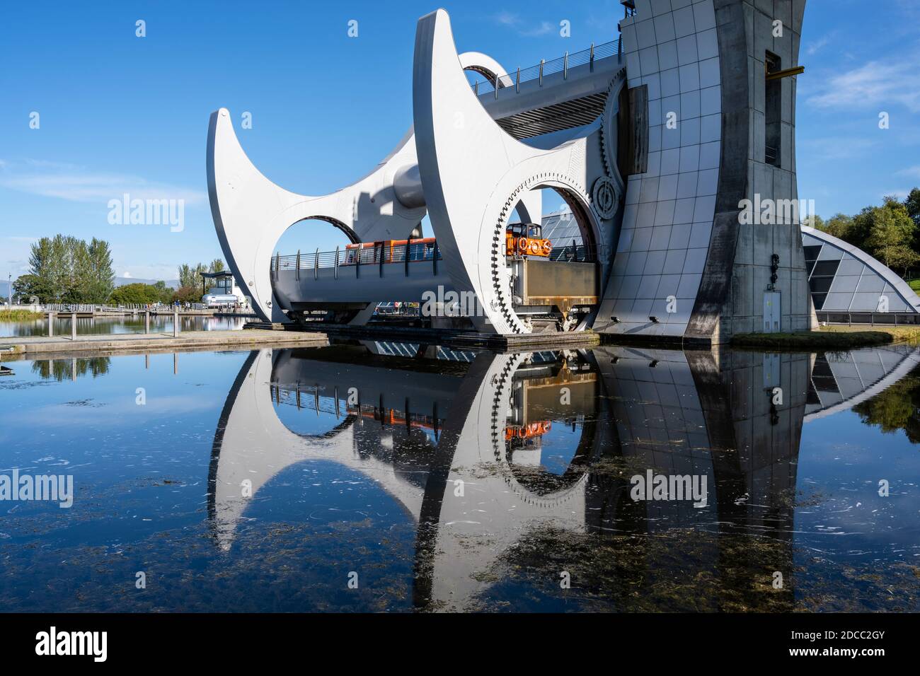 Canal boat descending from the top of the Falkirk Wheel rotating boat lift in Falkirk, Scotland, UK Stock Photo