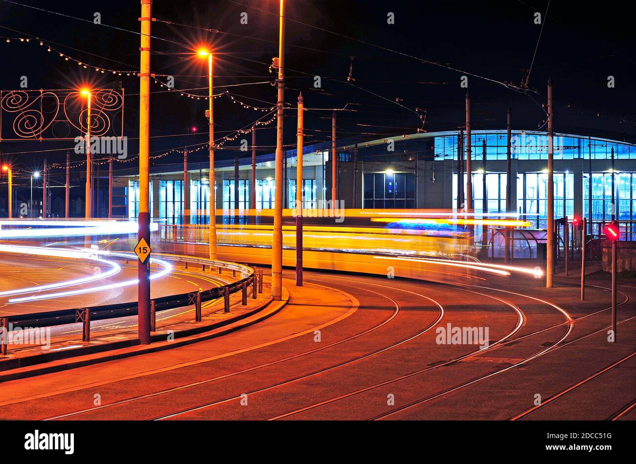Tram leaving depot terminus at night Stock Photo