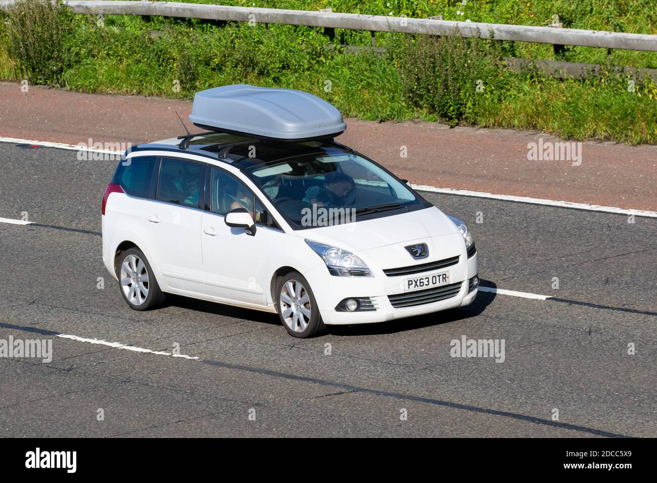 2003 white Peugeot 5008 Allure HDI with roof box; Vehicular traffic, moving vehicles, cars, vehicle driving on UK roads, motors, motoring on the M6 motorway highway UK road network. Stock Photo