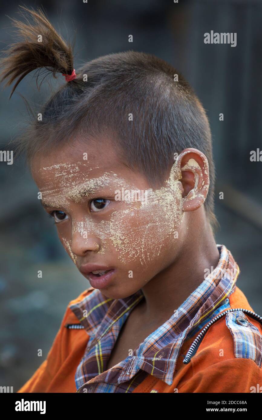 Daily life in Myanmar - young boy with thanakha on face and fashionable  hairstyle at Yangon, Myanmar (Burma), Asia in February Stock Photo - Alamy