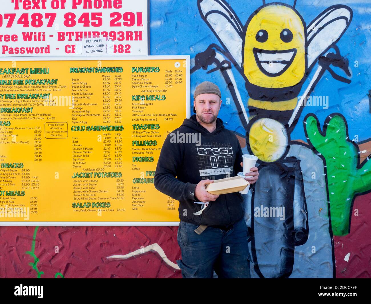 Self-employed James, who works in concrete, and who says 'business is good', with his food and drink purchased from the Busy Bees Diner. Darrington. Stock Photo