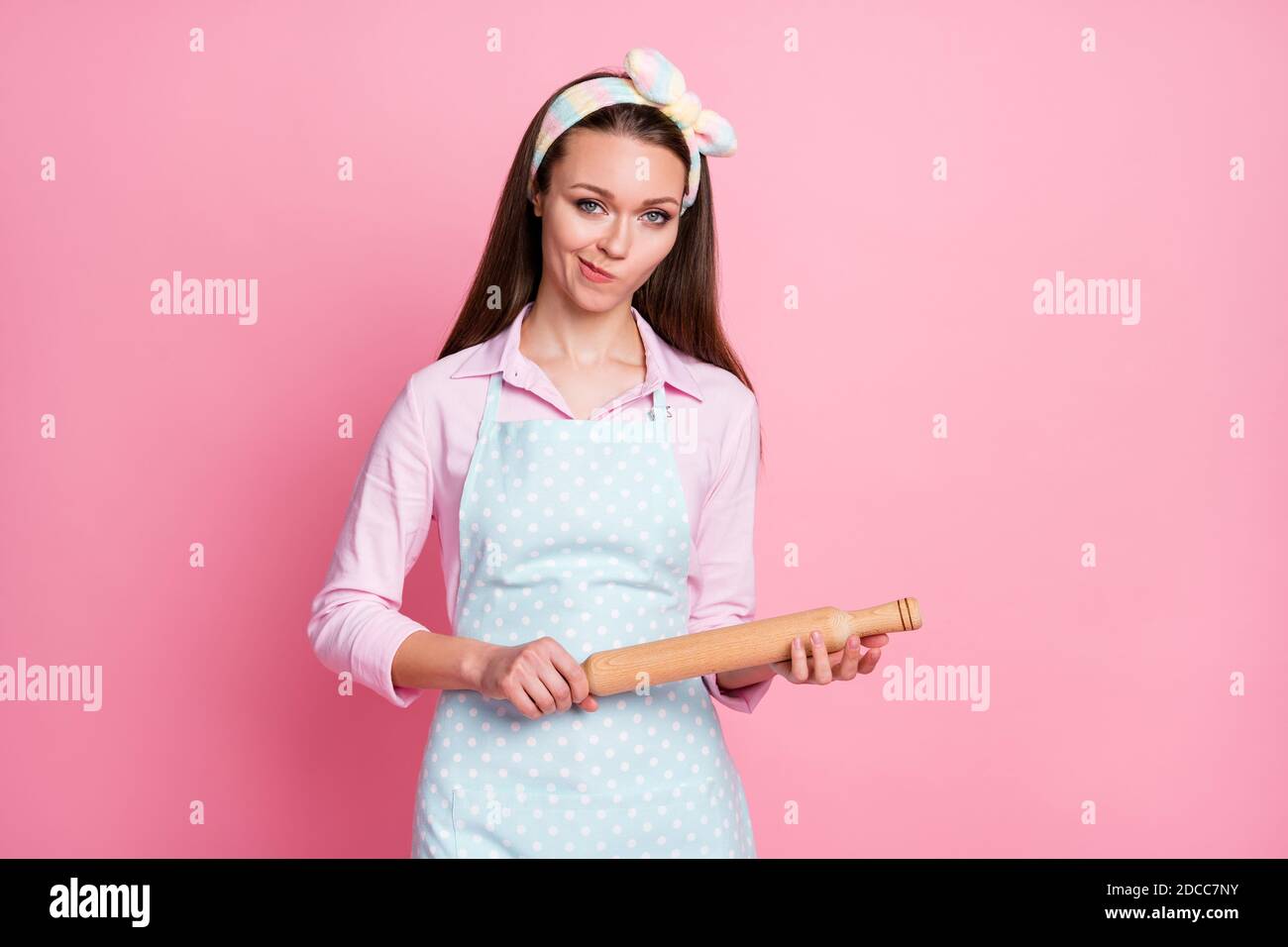 Portrait of angry frustrated mother hold rolling pin want start scandal wear good look clothes isolated over pink color background Stock Photo