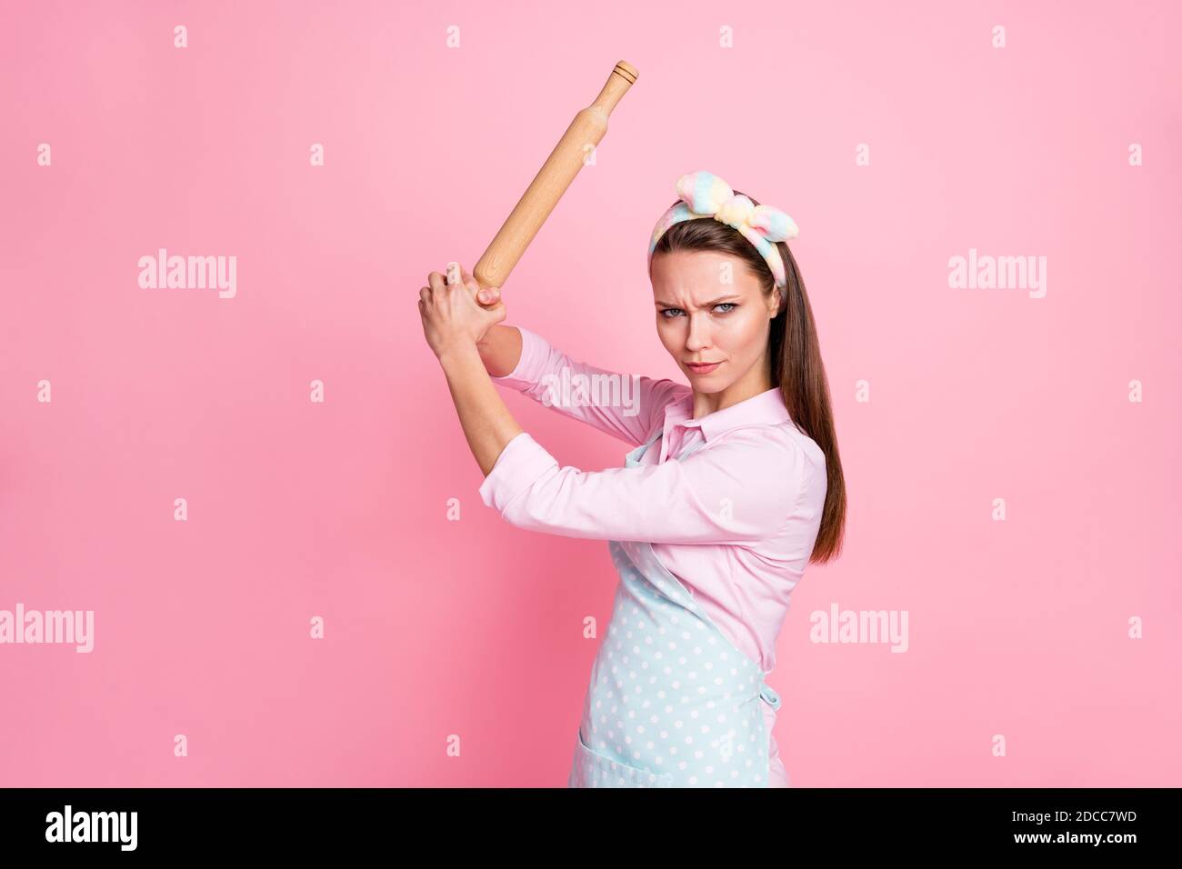 Portrait of her she nice attractive dangerous mad serious housewife holding in hands rolling pin threatening fighting rights gender equality isolated Stock Photo