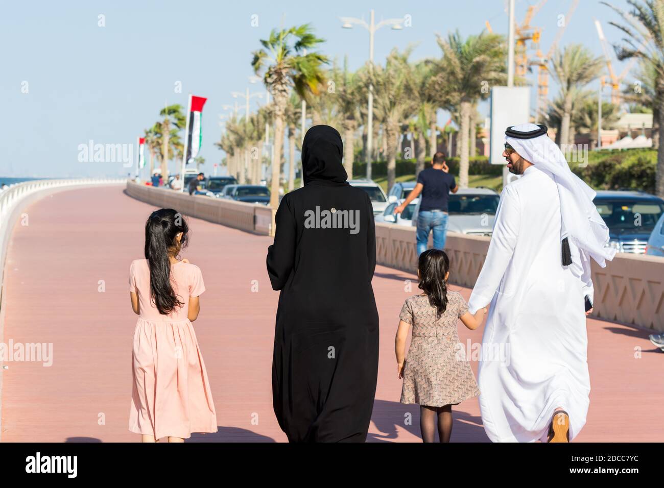 Arabic family wearting traditional drone and walking at the crescent