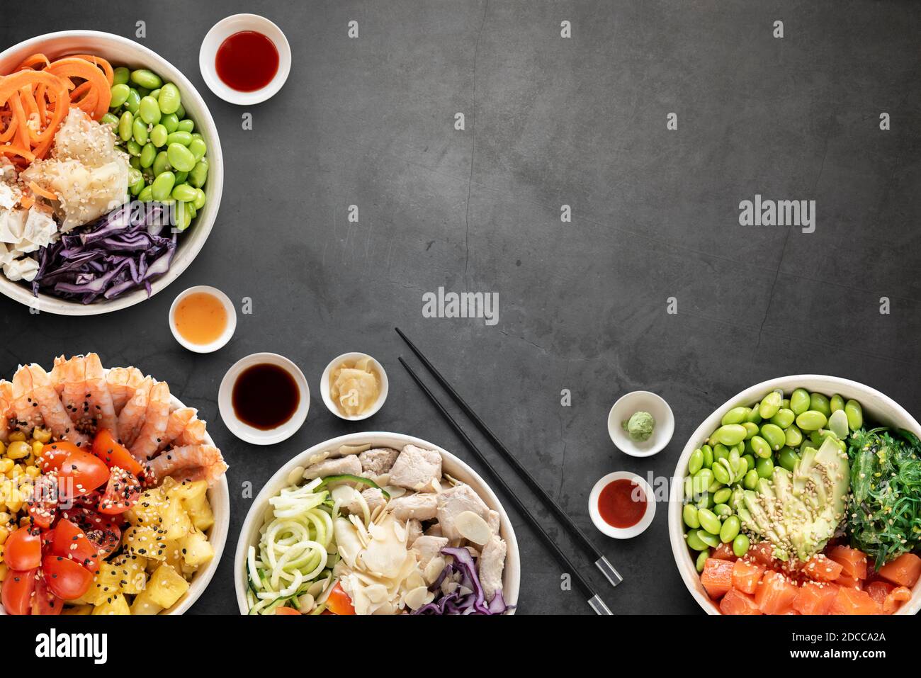 Top view of poke bowls composition with various sauces Stock Photo