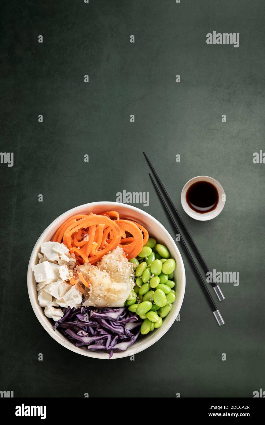 Top view of vegan poke bowl with chopsticks and soy sauce Stock Photo