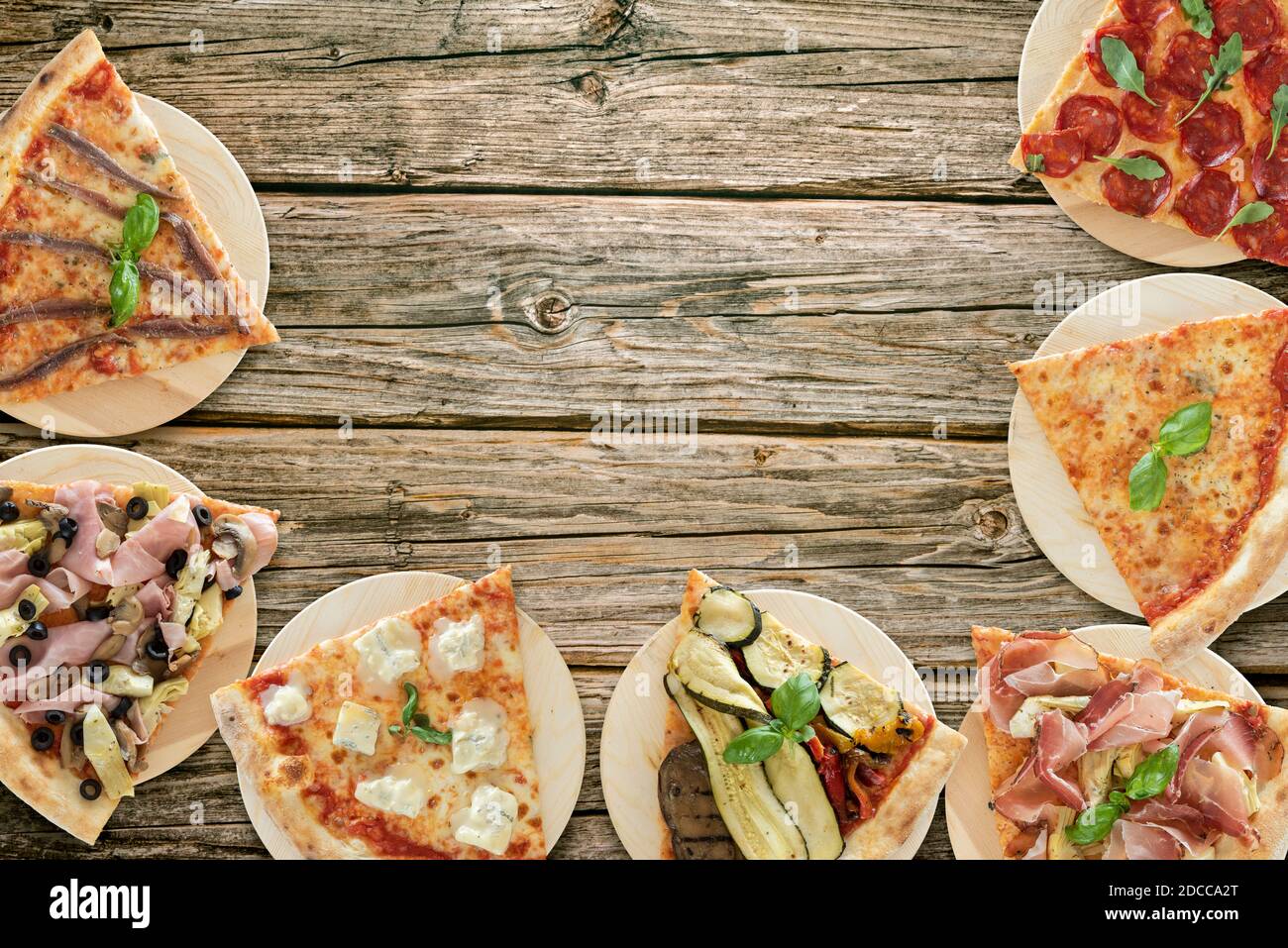 Top view of pizza slices variety on wooden cutting boards Stock Photo