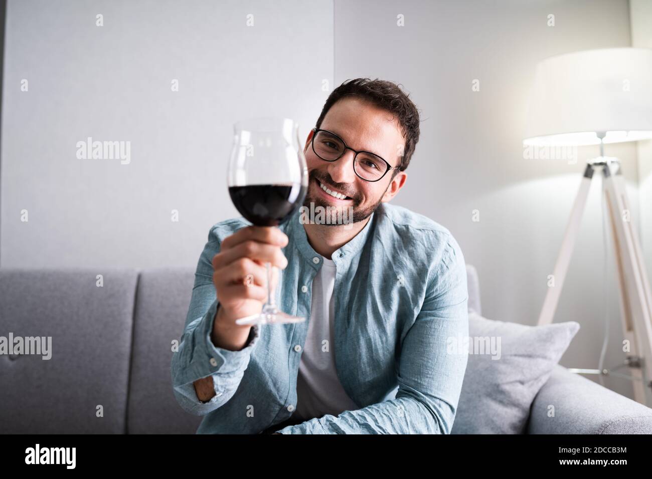 Man Drinking Red Wine In Video Conference At Home Stock Photo - Alamy