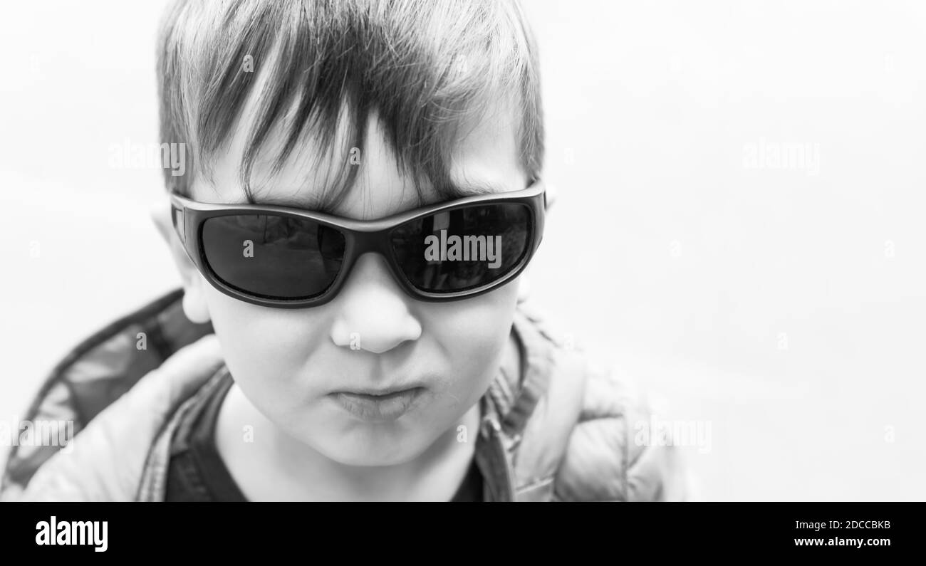 black-and-white-portrait-of-a-three-year-old-boy-with-sunglasses-stock