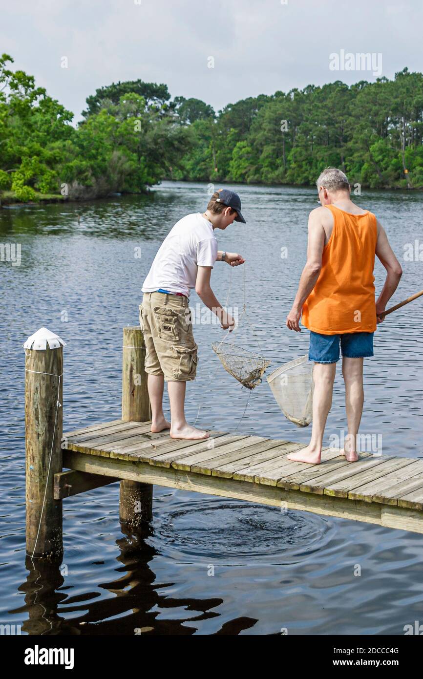 Louisiana St. Tammany Parish Northshore,Slidell,Liberty Bayou,crabbing fishing man teen teenager boy friends pier, Stock Photo
