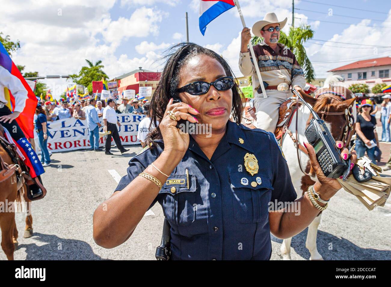 Miami Florida,Little Havana,Hispanic man men,Calle Ocho political protest Fidel Castro Hugo Chavez,signs banners marching Venezuelans Cubans,Black Afr Stock Photo