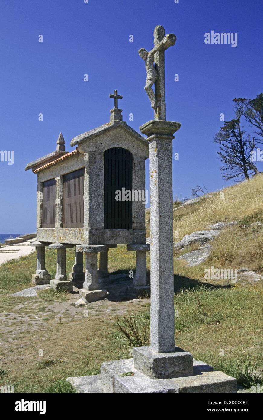 horreo (grain store) and crucifix in Baiona Rias Baixas Galicia Spain Stock Photo