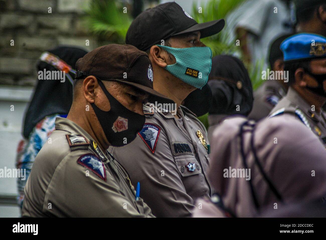 Police standing on guard during the demonstration. Hundreds of Muslims staged a demonstration at North Sumatra governor's office against religious leaders who were deemed to have committed religious blasphemy against Islam, the action was carried out by implementing health protocols in the COVID-19 pandemic. Stock Photo