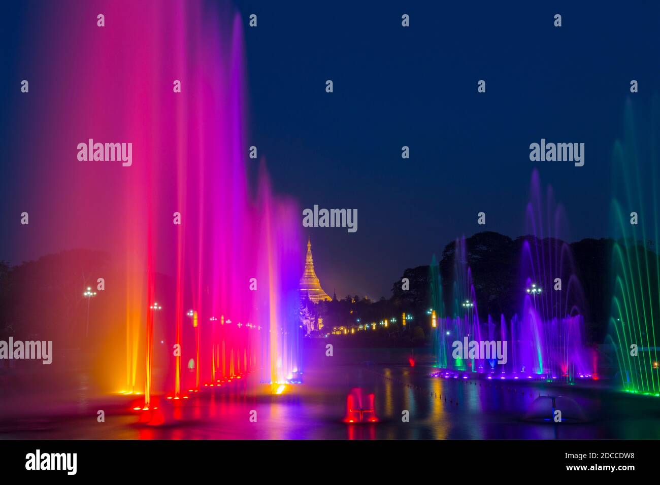 Public Square People's Park with lit illuminated water fountains and Shwedagon Pagoda, Yangon, Myanmar (Burma), Asia in February Stock Photo