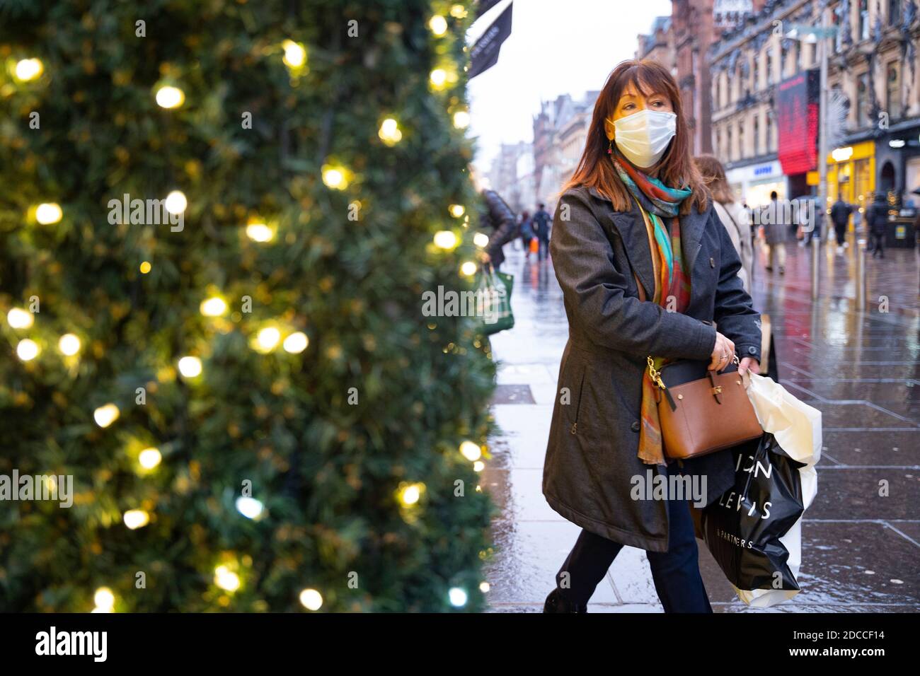 Glasgow, Scotland, UK. 20 November 2020. On the day when the severest level 4 lockdown will be imposed at 6pm, shoppers are out on the streets of Glasgow doing last minute Christmas shopping before the shops close for 3 weeks. Pictured; Woman shopping on Buchanan Street.  Iain Masterton/Alamy Live News Stock Photo