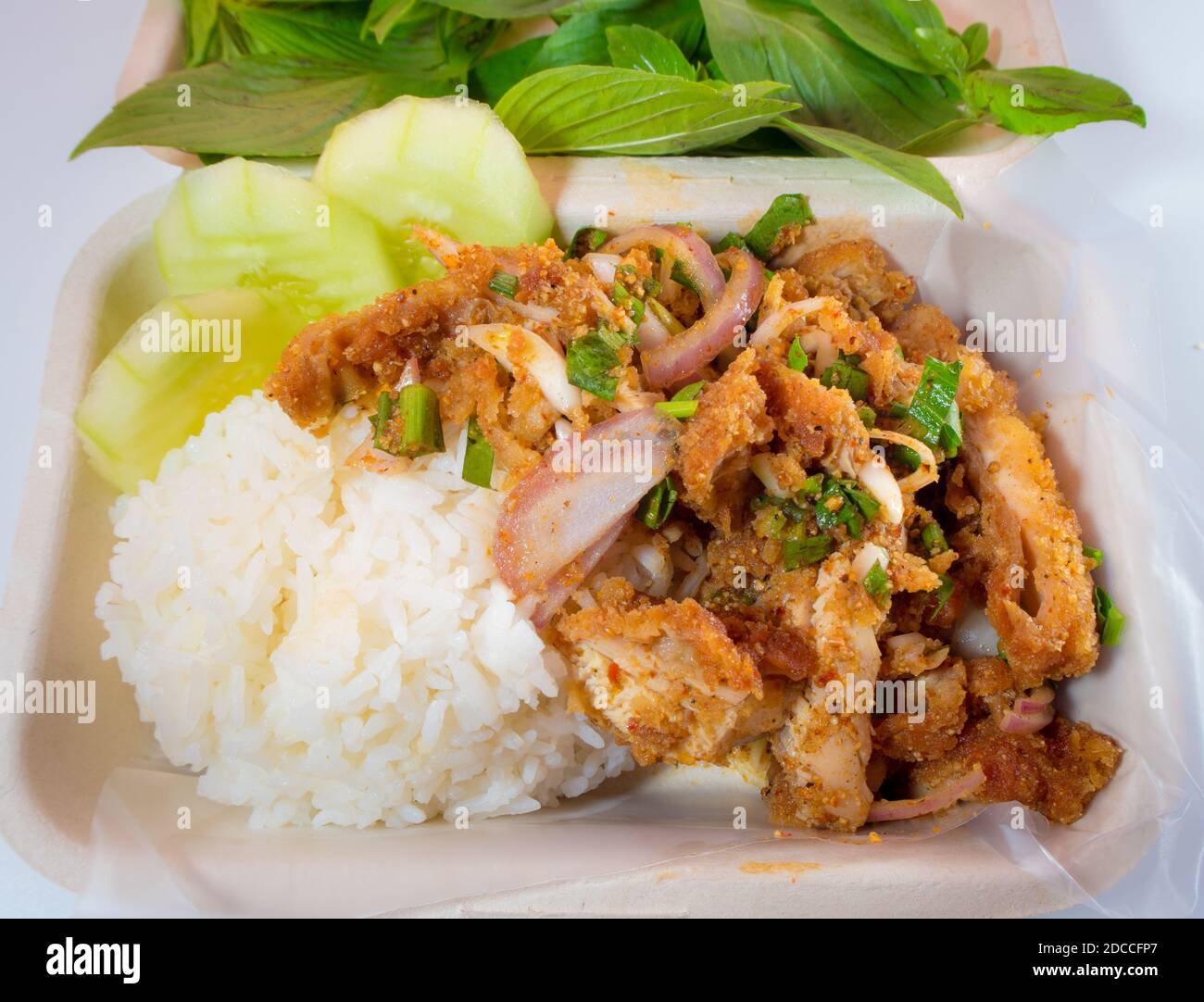 Cooked rice with Spicy Chicken Salad in Eco Food box Stock Photo - Alamy