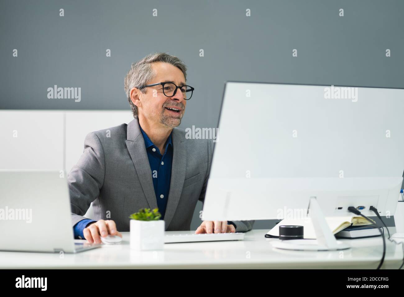 Happy Professional Man Employee Using Computer For Work Stock Photo - Alamy