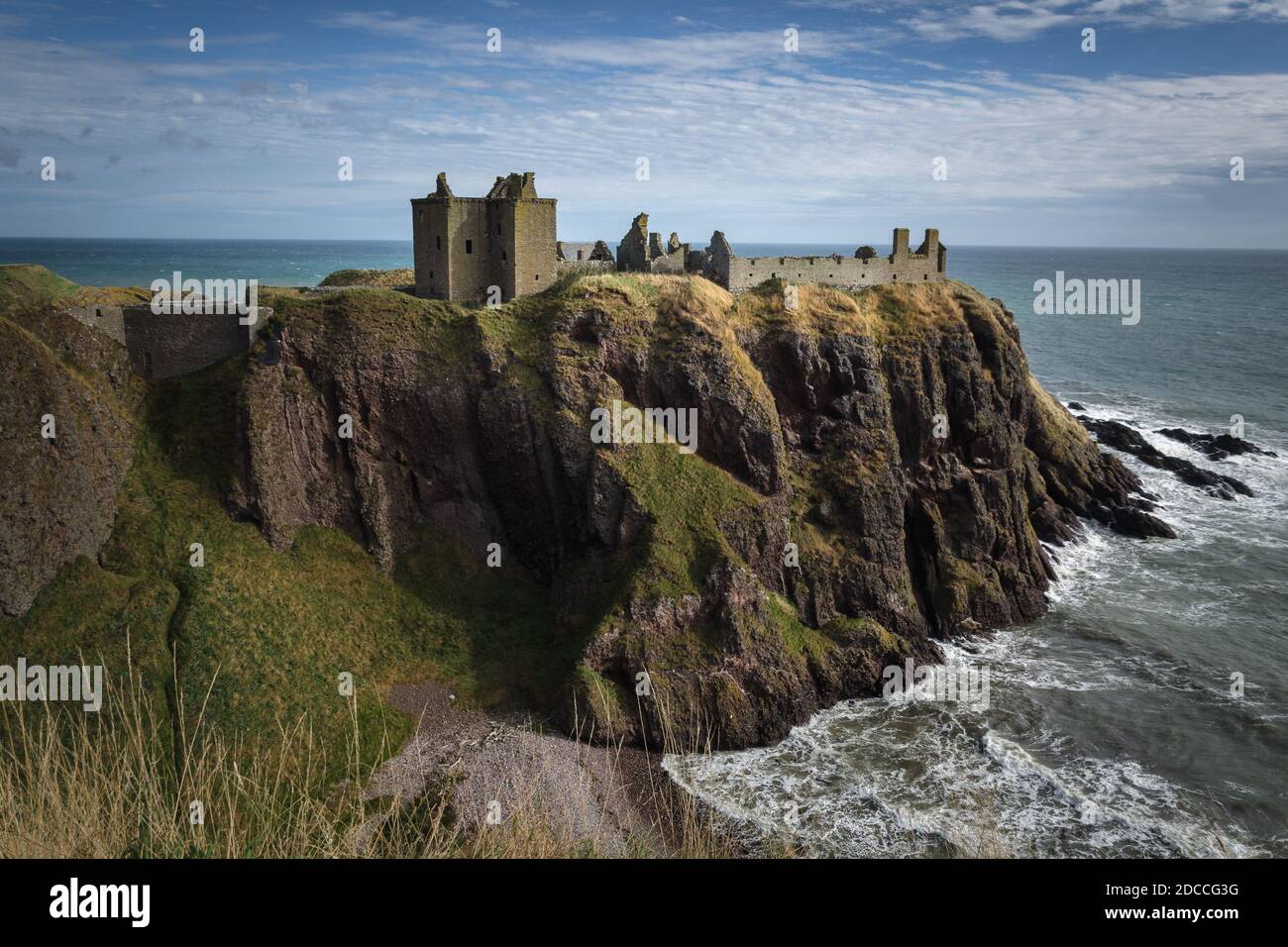 Dunnottar Castle on top of a cliff by the sea on a cloudy day, Stonehaven, Scotland, United Kingdom Stock Photo