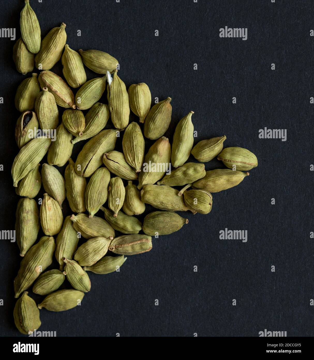 Close up photo of Cardamom pods pile formed as PLAY sign icon on the ...