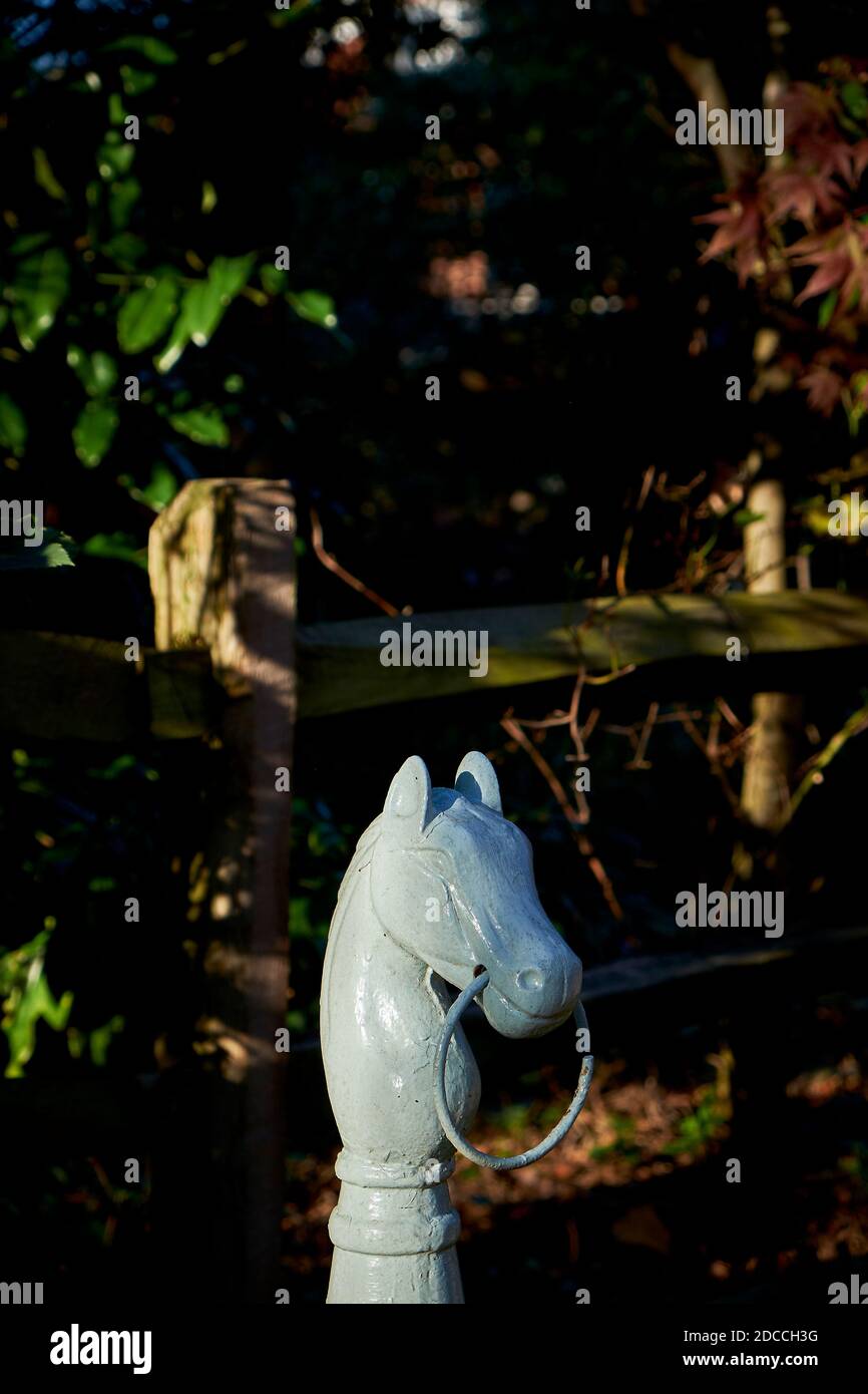 An old, painted, wrought iron horse head hitching post in Dickeyville