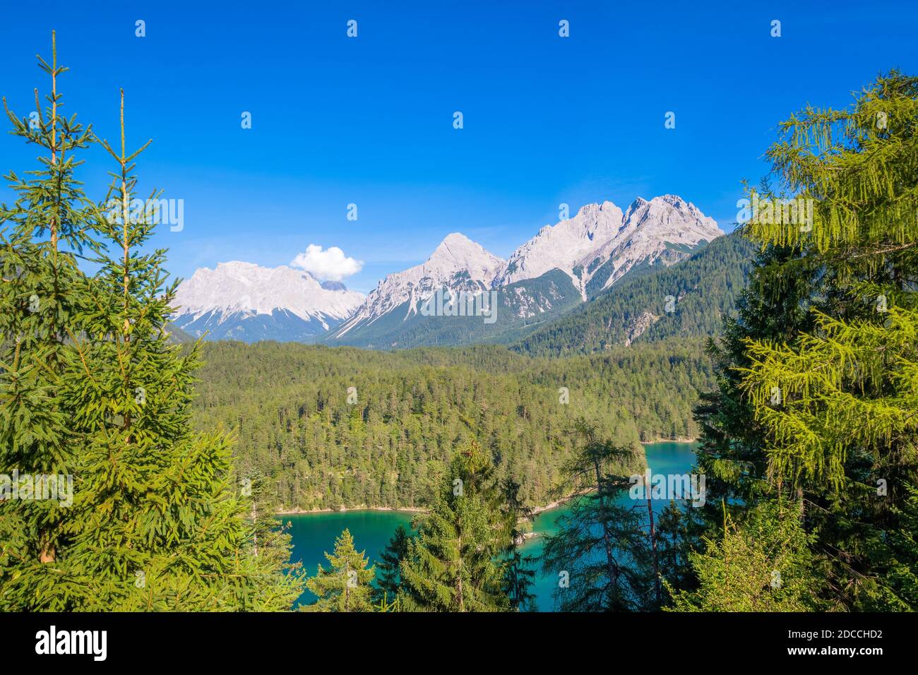 Look at the highest mountain of Germany, the Zugspitze, and the blindsee near Biberwier from a observation deck located in Austria on the Fern Pass Stock Photo