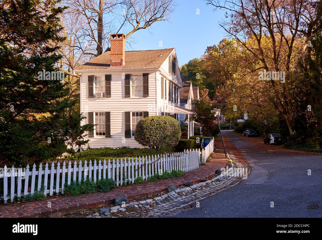 White picket fence and houses on a street in Dickeyville, the Colonial ...