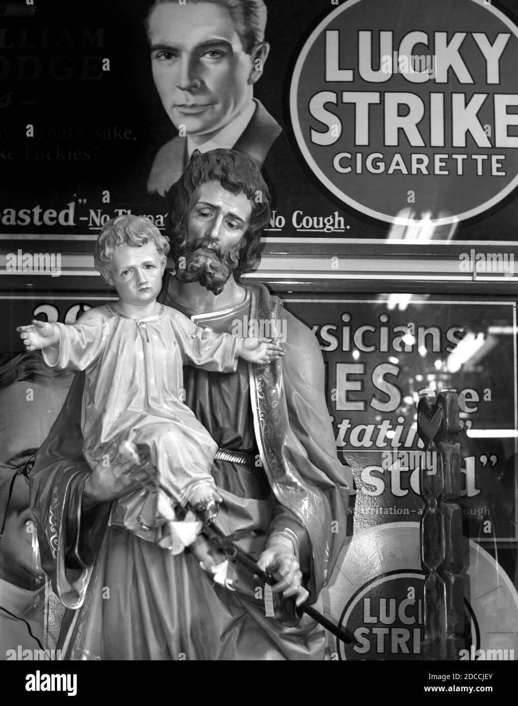 A wooden sculpture of St. Joseph holding the Baby Jesus carved in Austria in the 1890s for sale in an antique shop in Santa Fe, New Mexico. Stock Photo