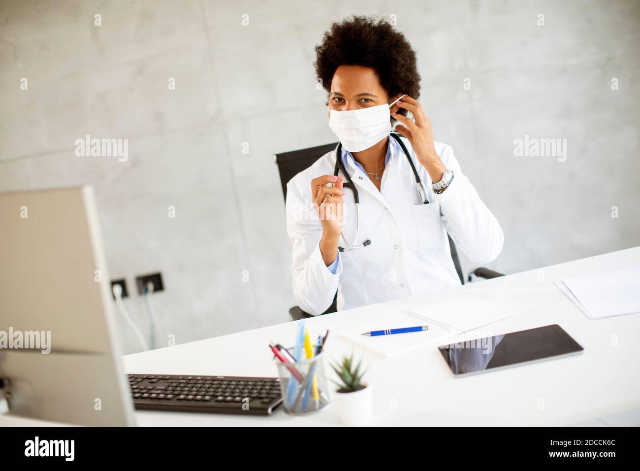 African woman taking off covid hi-res stock photography and images - Alamy