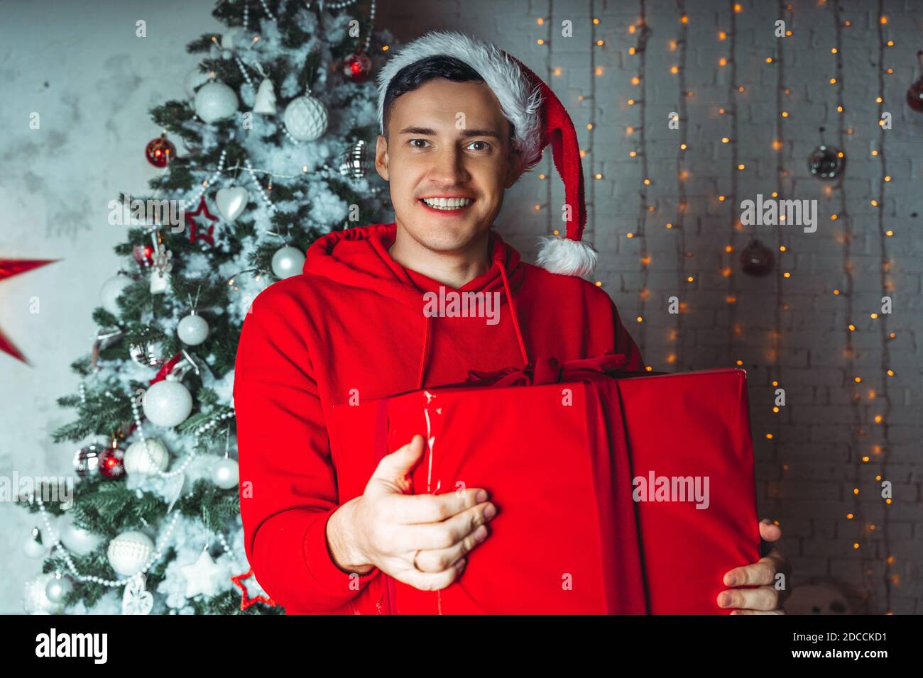 Young handsome man in Santa Claus hat 