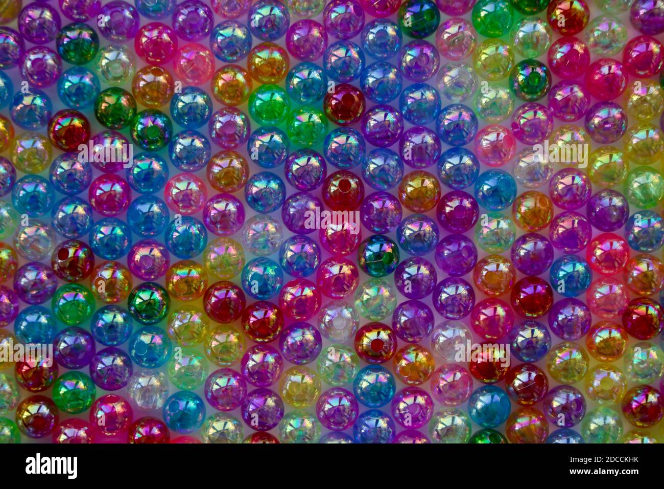Set of transparent, shiny and many-coloured beads looking like soap bubbles. Seed beads for use in necklaces and bracelets. Stock Photo