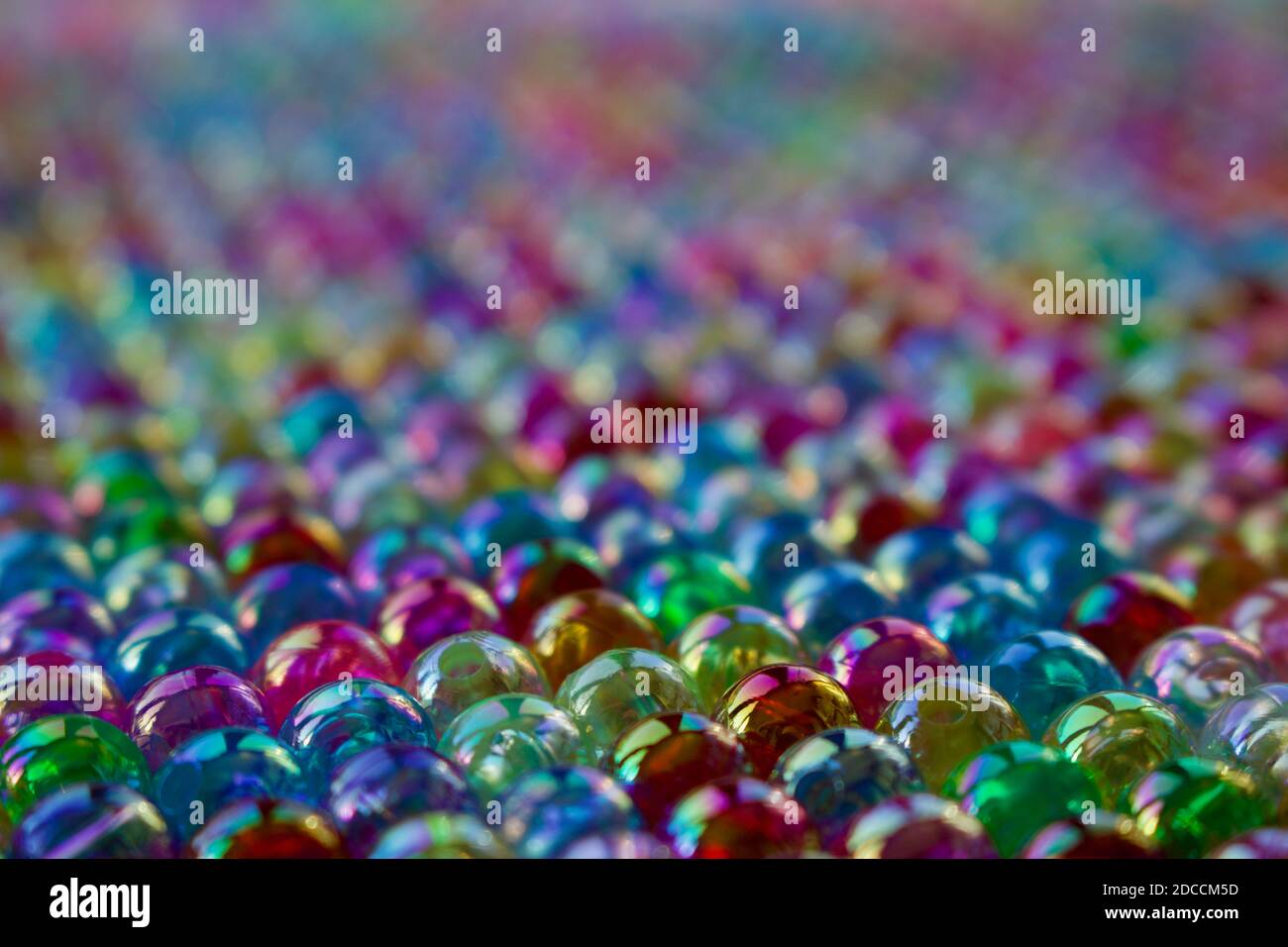 Set of transparent, shiny and many-coloured beads looking like soap bubbles. Seed beads for use in necklaces and bracelets. Stock Photo