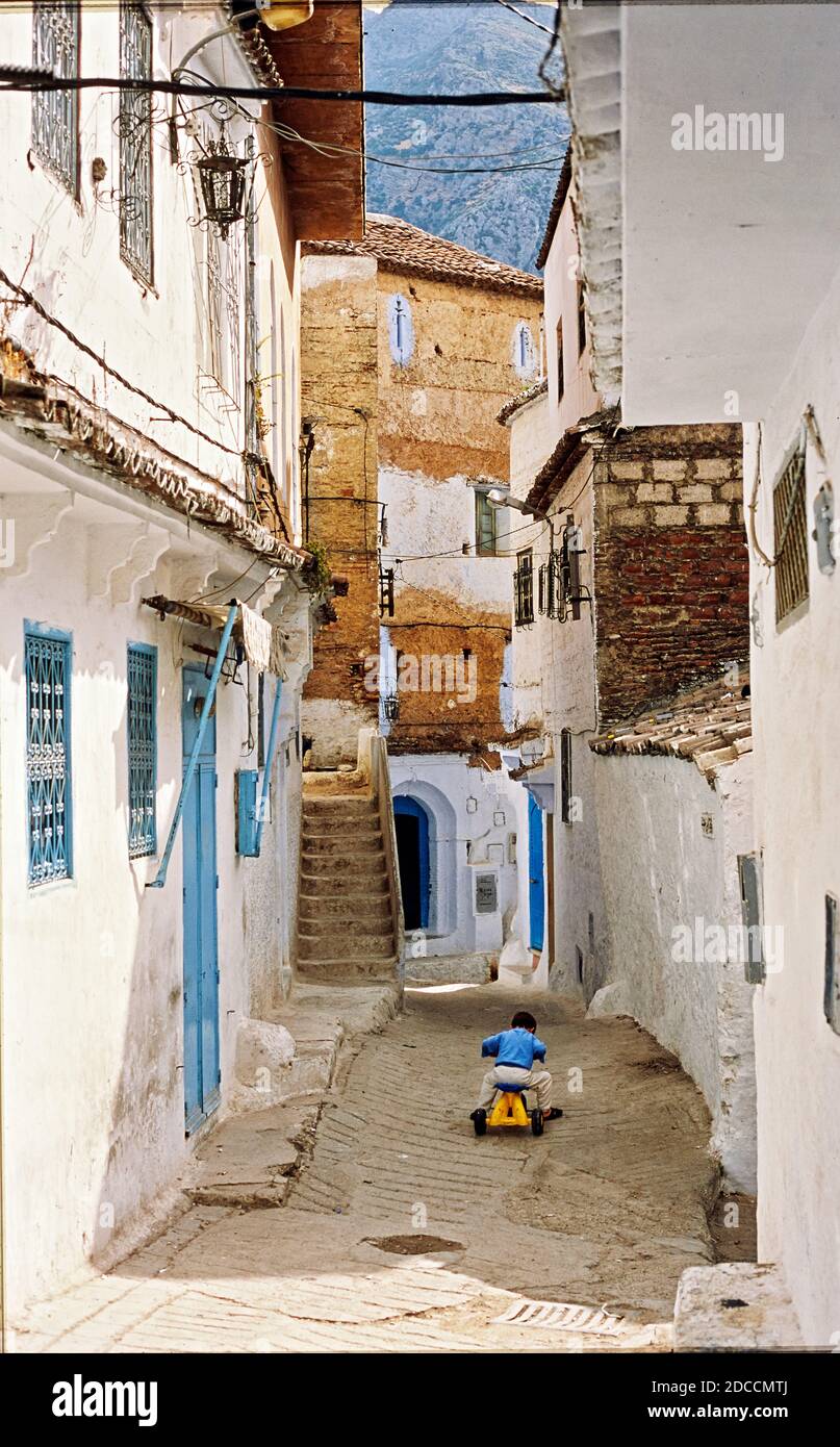 Streets and alleys of the Medina of Chefchaouen, Morocco. A child is playing on the street Stock Photo