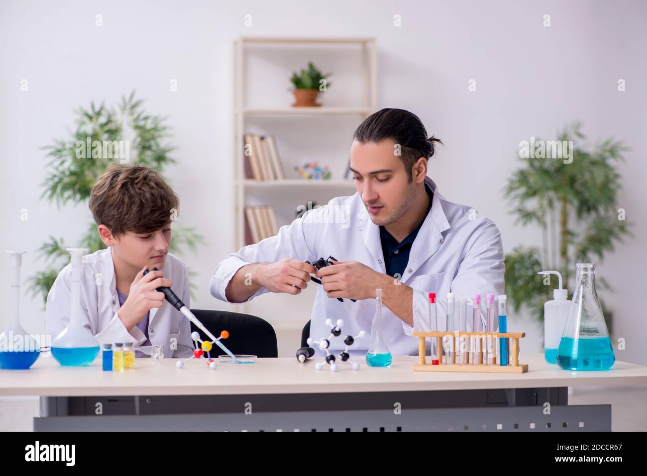 Father's Hidden Lab Young father and son chemists in the laboratory Stock Photo - Alamy