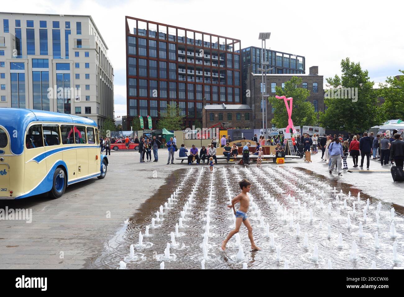 Great Britain / England /London / Granary Square fountains at King's Cross London. Kids in sprinklers at Granary Square Water Feature in Kings Cross. Stock Photo