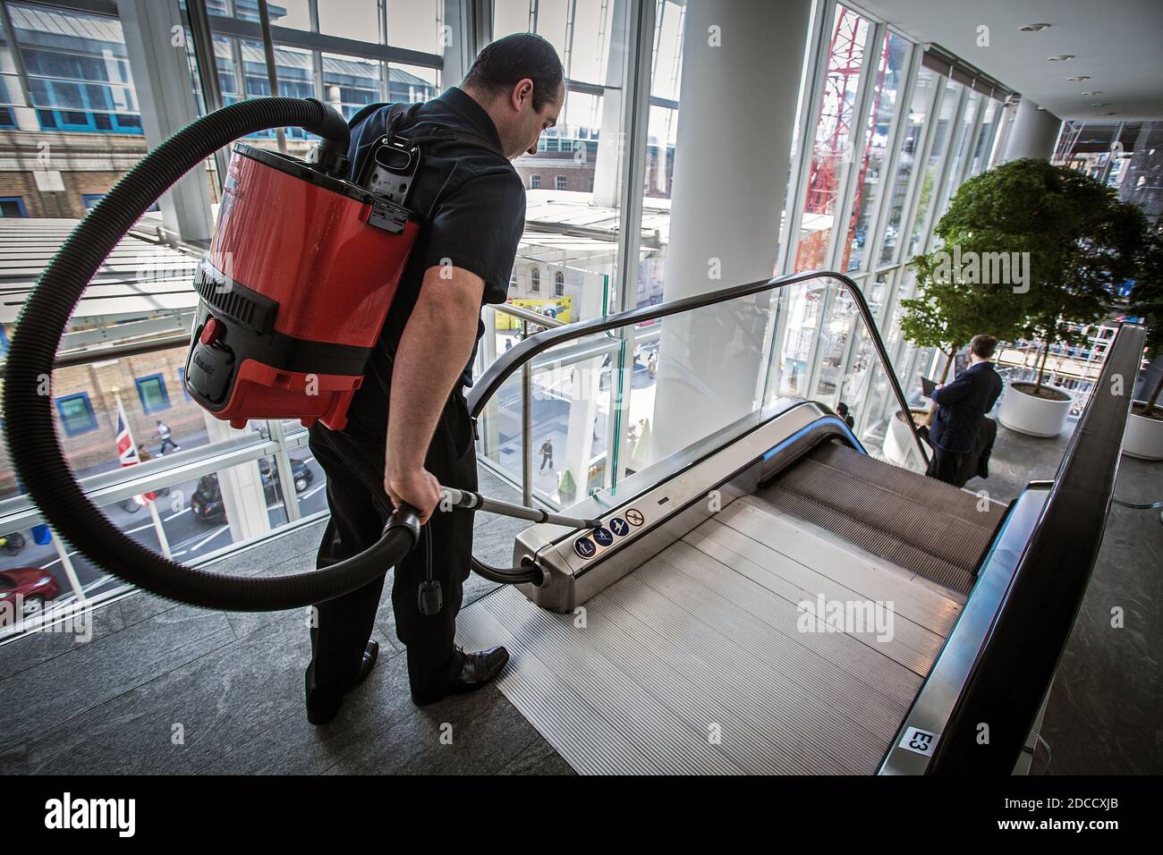 Great Britain / England /London /  Cleaner with backpack  vacuum cleaner at the Shard . Stock Photo