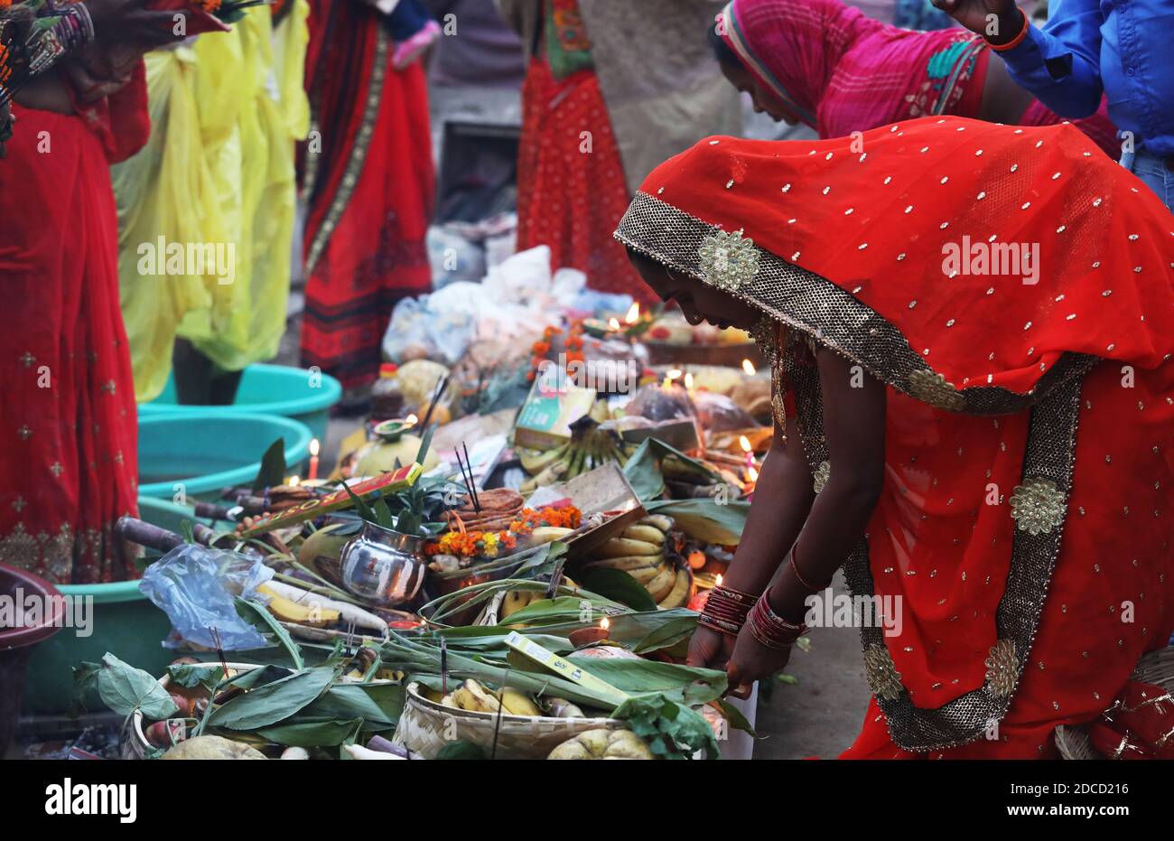 Hindu women devotees offer their prayers to God 'Sun' on the auspicious occasion of the Chhat Puja.Chhath Puja festival, also known as Surya Pooja (worship of the sun), is observed in eastern parts of India where homage is paid to the sun and water Gods. Due to covid19 restrictions devotees celebrate Chhath Puja festival at their homes after Delhi High Court banned the festival. Stock Photo