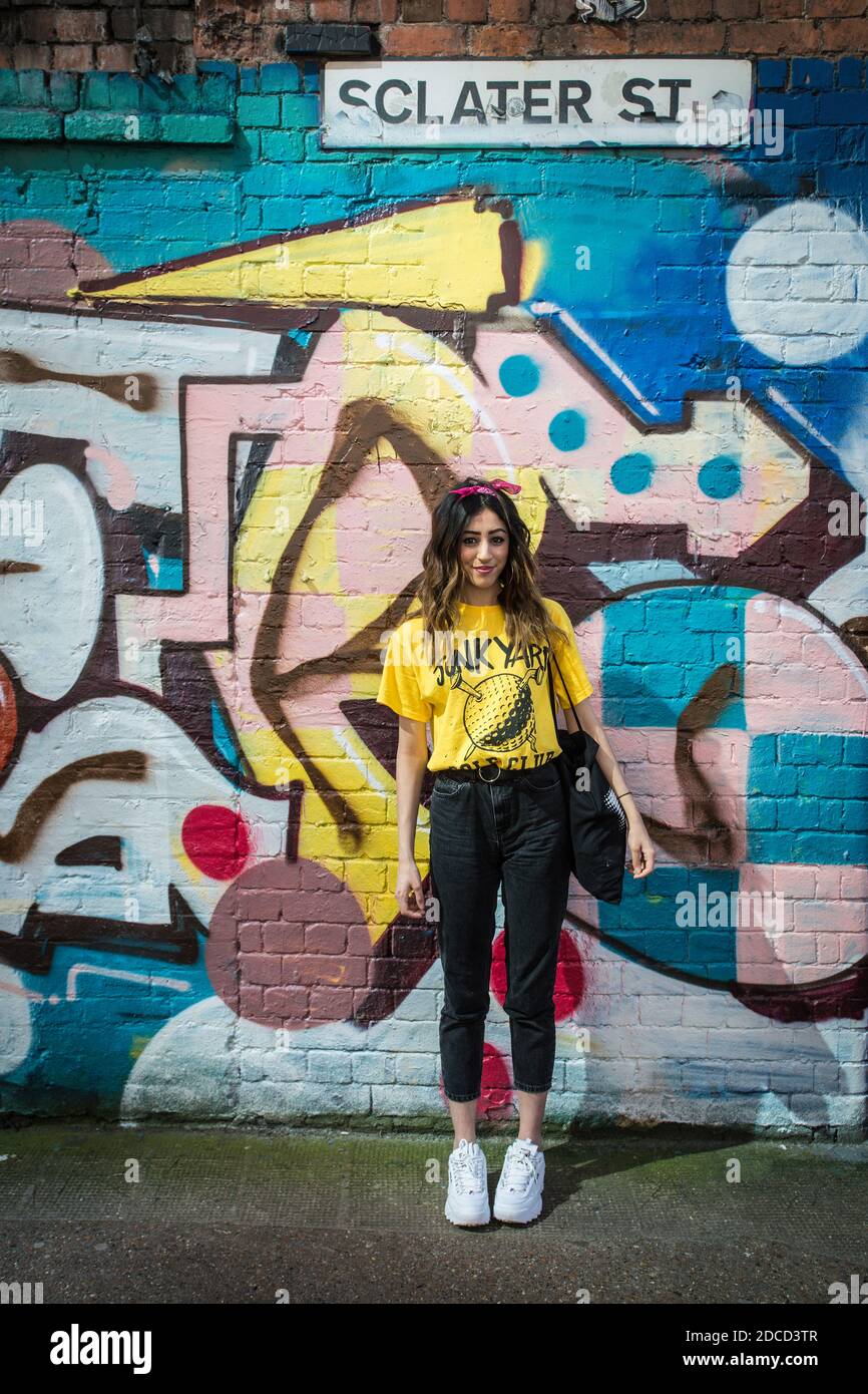 Street fashion portrait of young woman in the cool fashion district in east London Shoreditch , UK Stock Photo