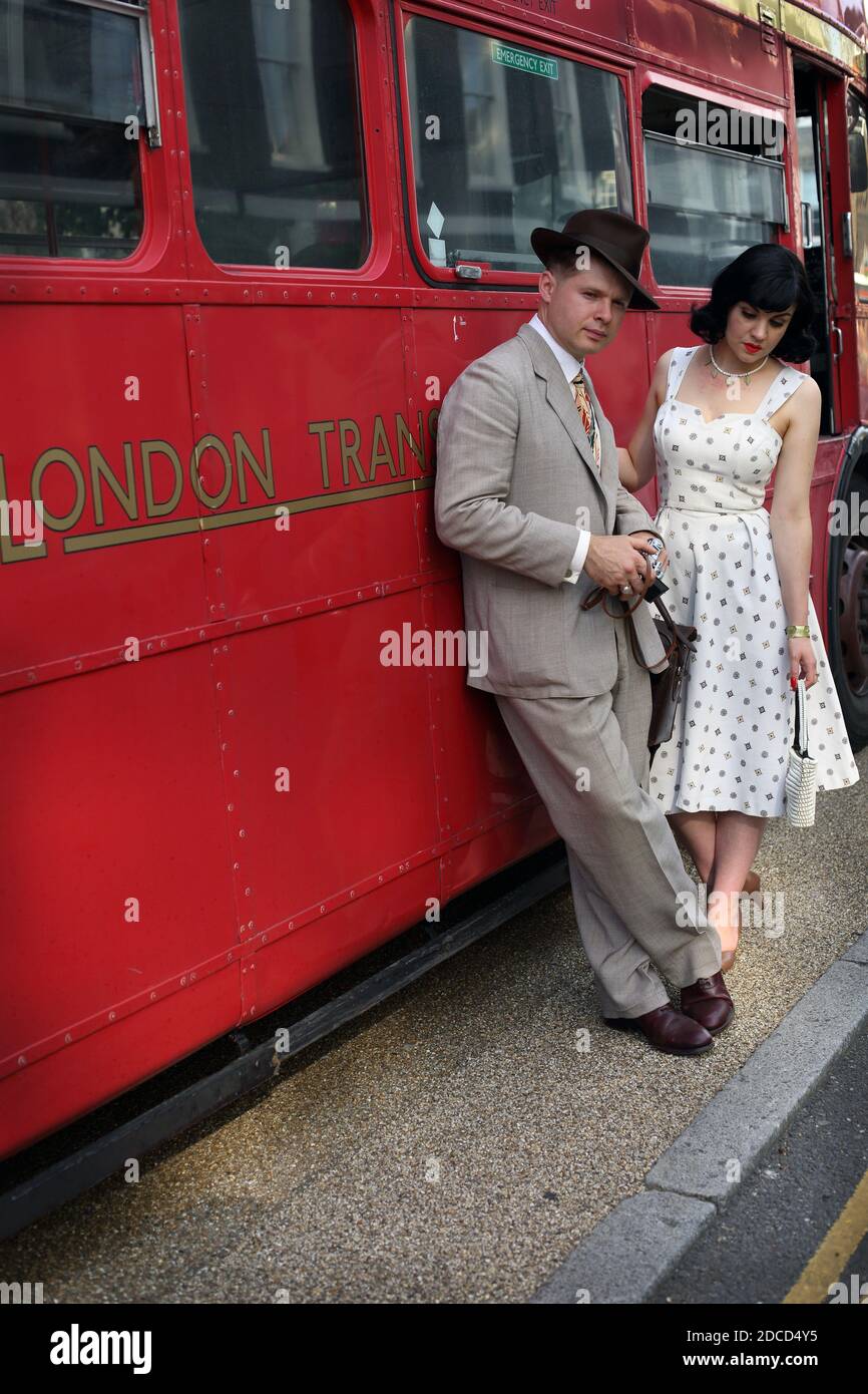 GREAT BRITAIN / England /London / Chap Olympiad/ Couple in vintage clothing  posing in front of iconic London Bus. Stock Photo