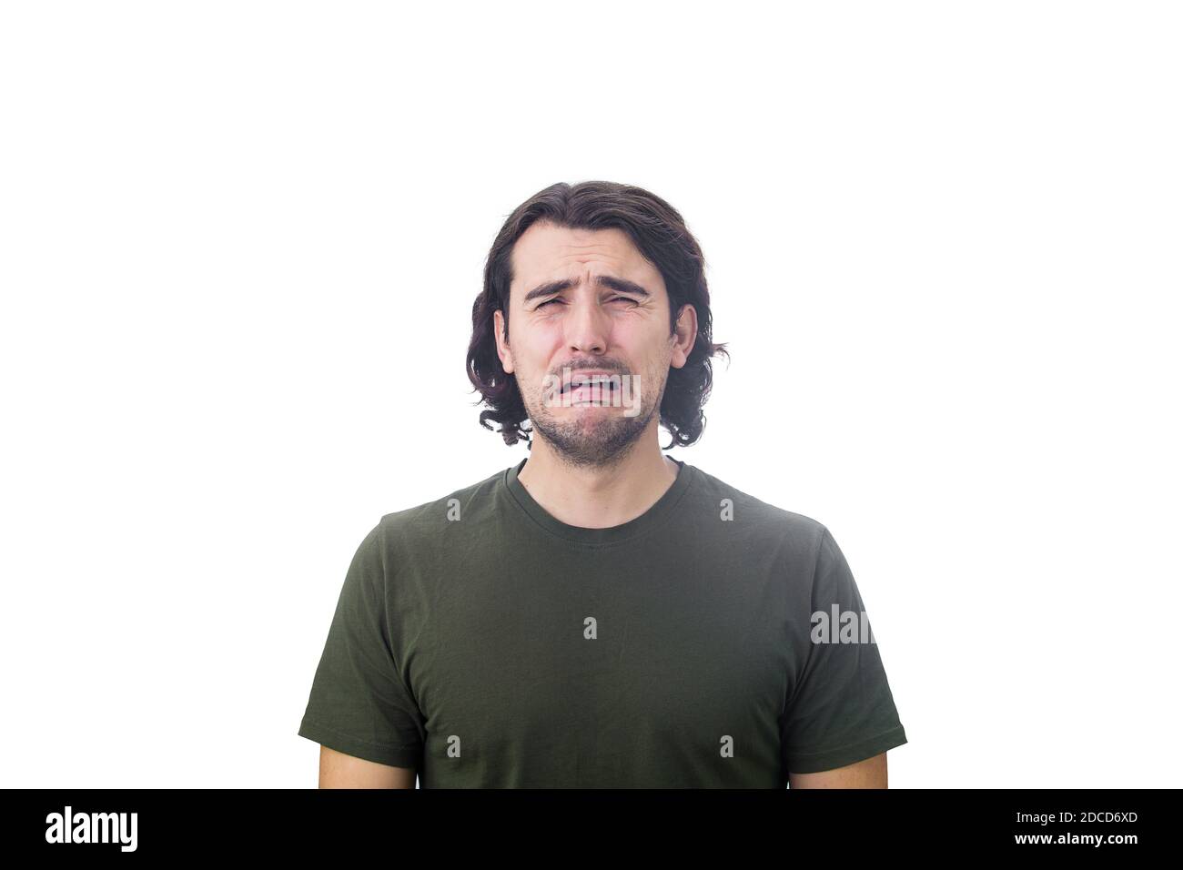 Portrait of desperate young man crying isolated on white background. Dissatisfied and disappointed guy sobbing and weeping to camera. Stock Photo
