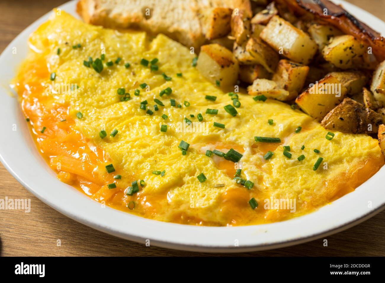 Homemade Healthy Cheese Omelet for Breakfast with Potatoes and Bacon